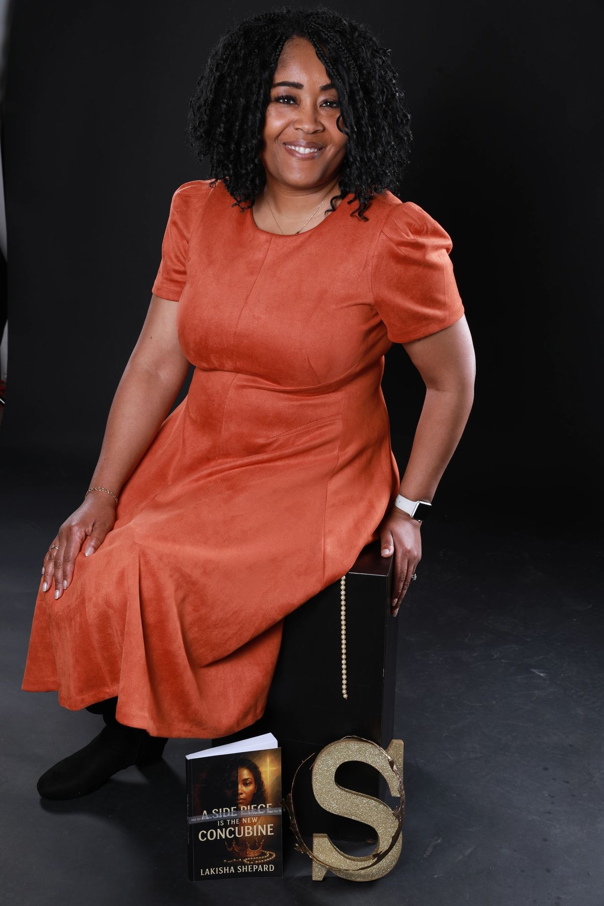 Lakisha Shepard seated beside her book