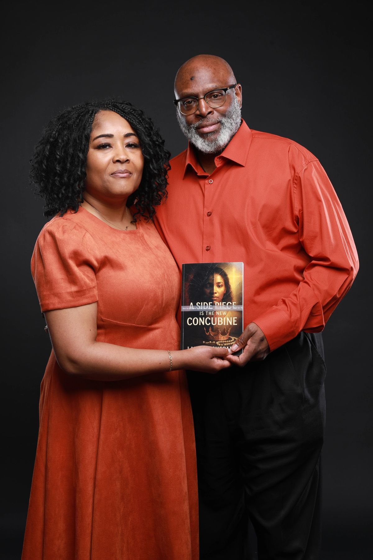 Lakisha Shepard and Bishop Owens Shepard holding the book